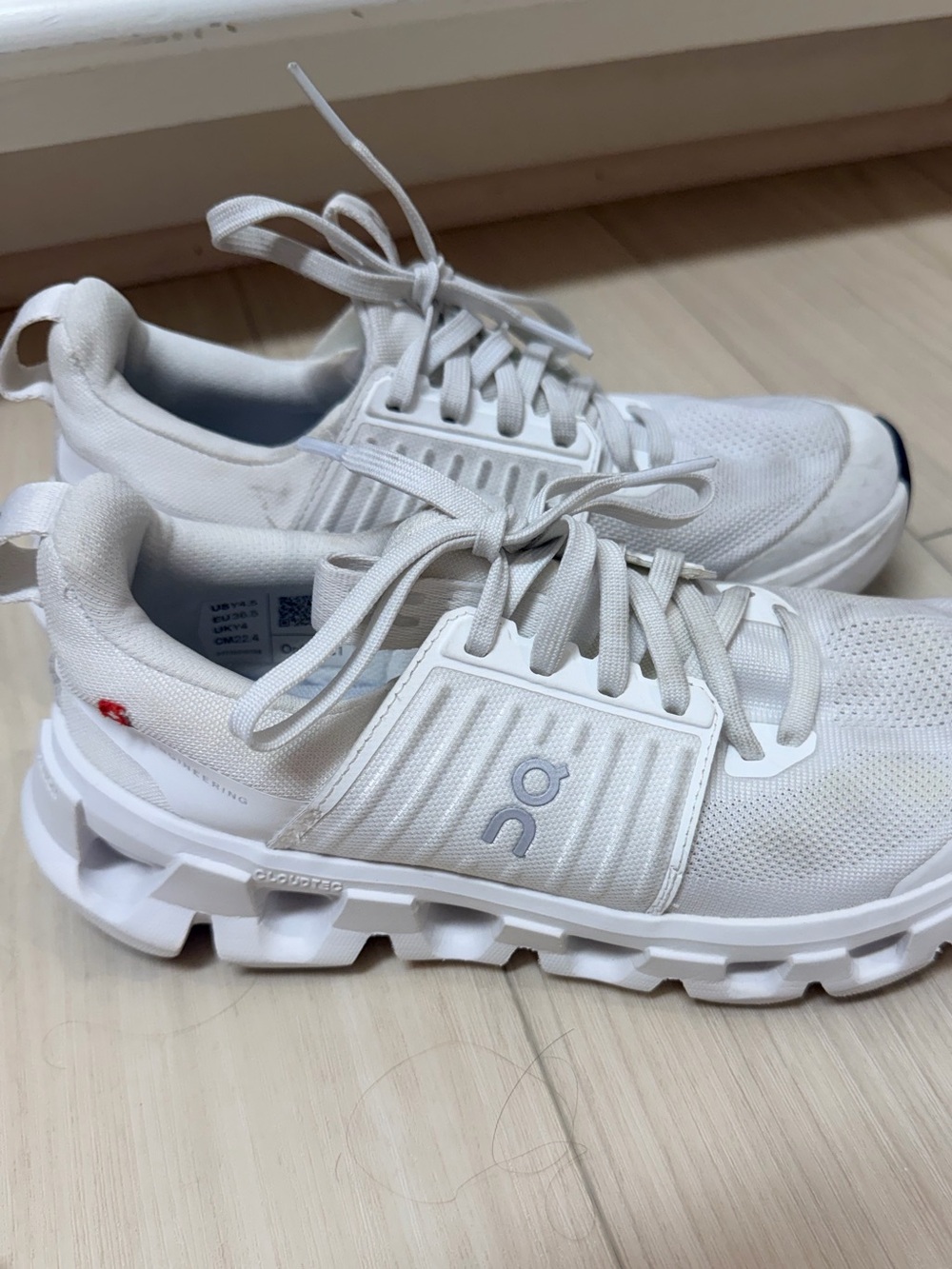 On Running Cloud Trainer women’s Sneakers in White with Subtle Red Accent
